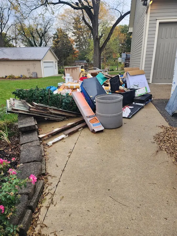 Dumpster being loaded with debris for Residential Dumpster Rental in St. Stephens